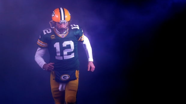 Green Bay Packers QB Aaron Rodgers runs out  of the tunnel at Lambeau Field